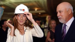 Celine Dion wearing a Scéno Plus helmet and René Angélil at a press conference for the opening of the Colosseum.
